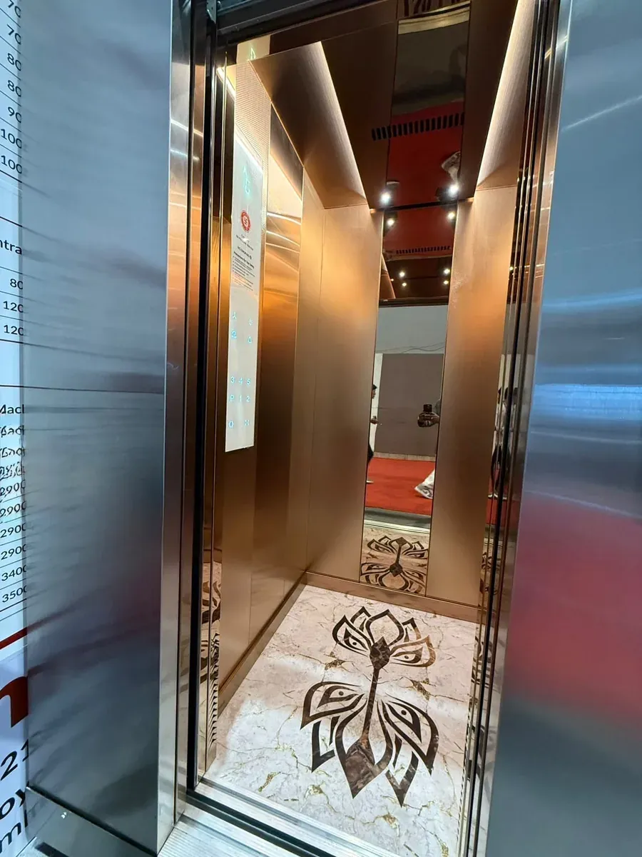 Rose-gold cabin with a lotus floor inlay and slim car operating panel