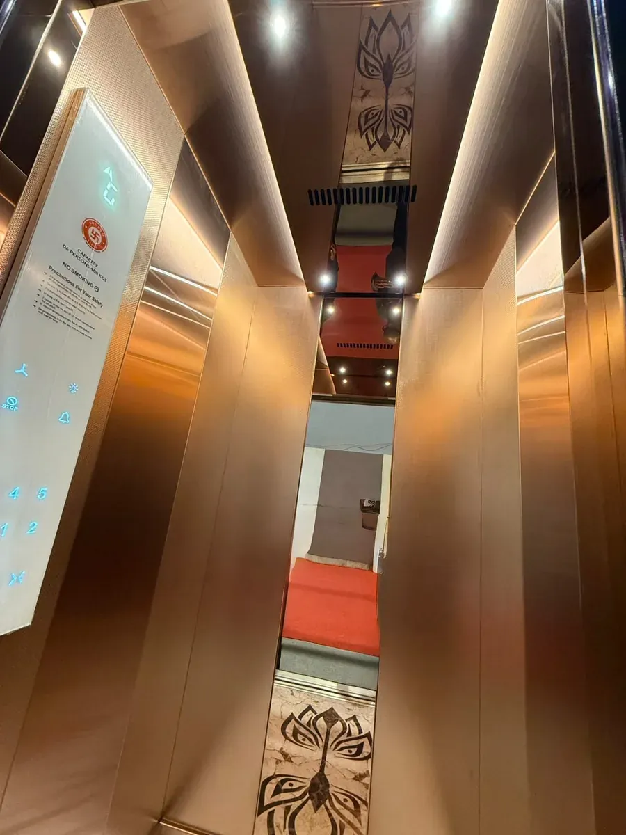 Upward view of a rose-gold cabin with a sculpted ceiling