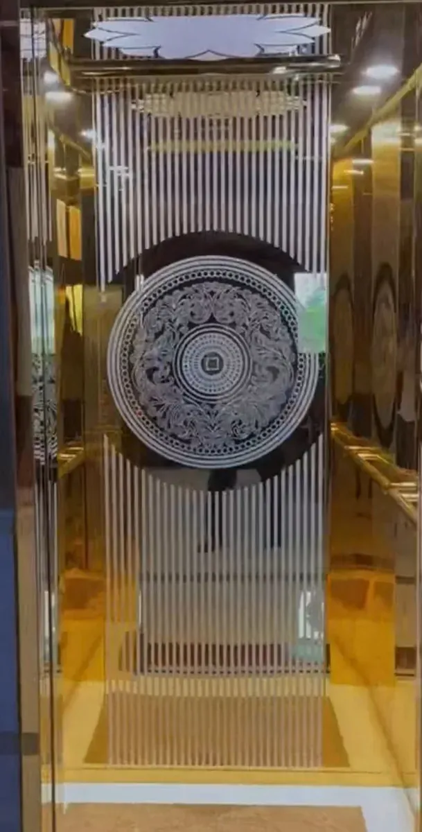 Gold cabin with vertical line etching and a medallion feature panel