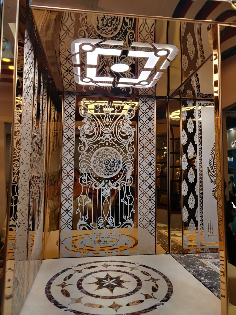 Mirror-gold cabin with ornamental etched panels and a star-pattern floor