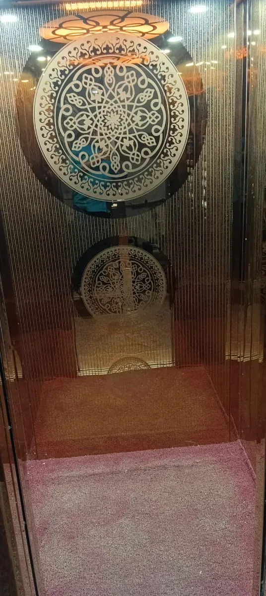 Bronze-tone cabin with a large etched medallion and ornate ceiling