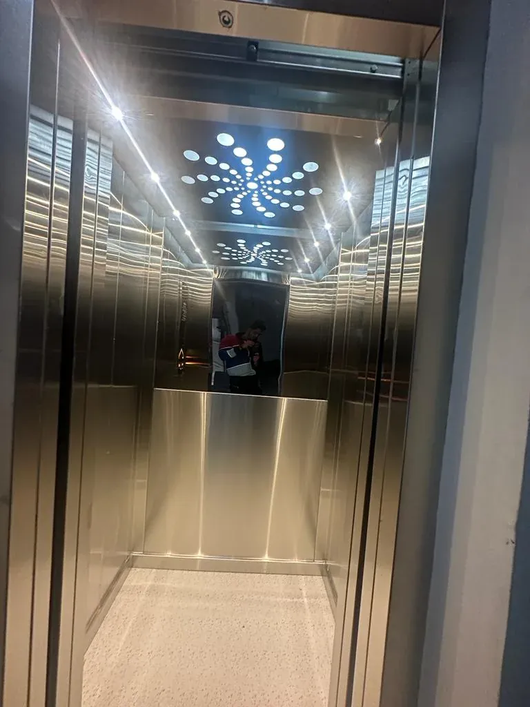 Hairline steel cabin with a sculpted LED ceiling
