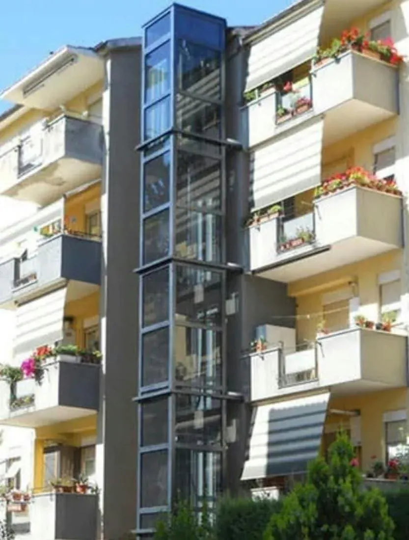 Glass lift shaft on the facade of a residential building