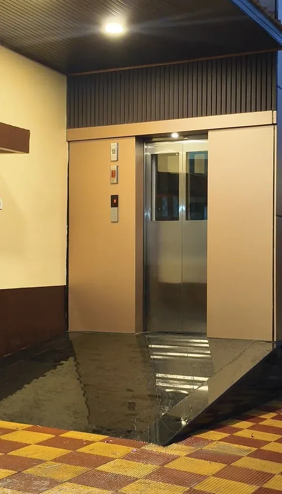 Stainless steel landing doors at a building entrance
