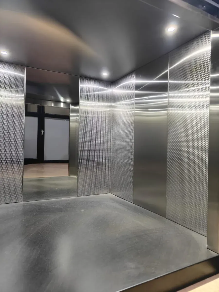 Spacious stainless steel cabin with textured wall panels
