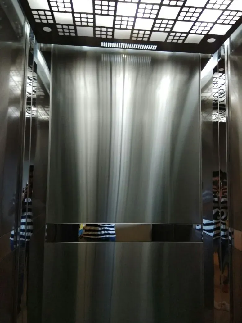 Brushed stainless cabin with a grid-pattern illuminated ceiling