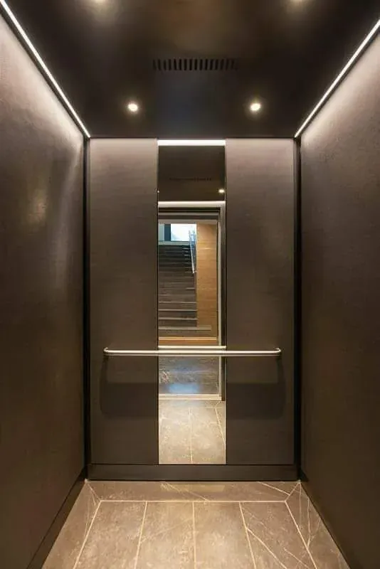 Charcoal-finish cabin with linear lighting and a mirror strip