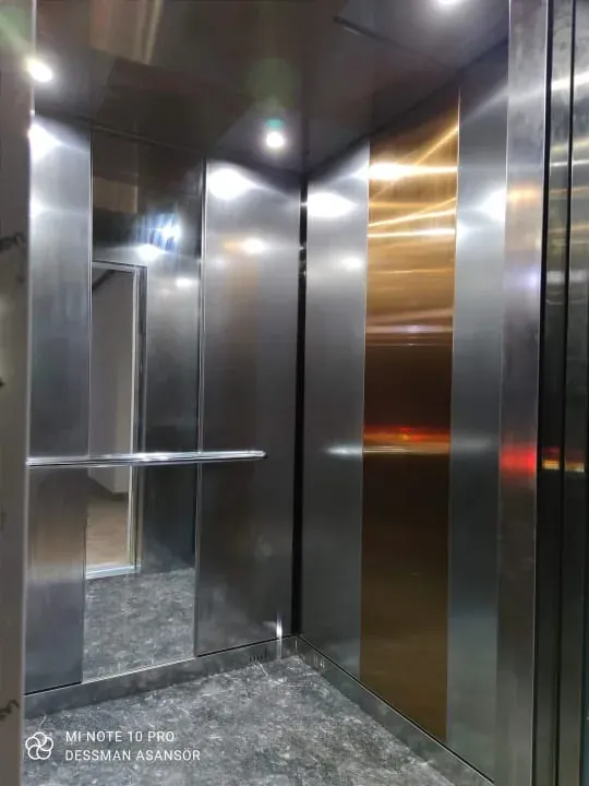 Stainless cabin with mirror panels and marble flooring